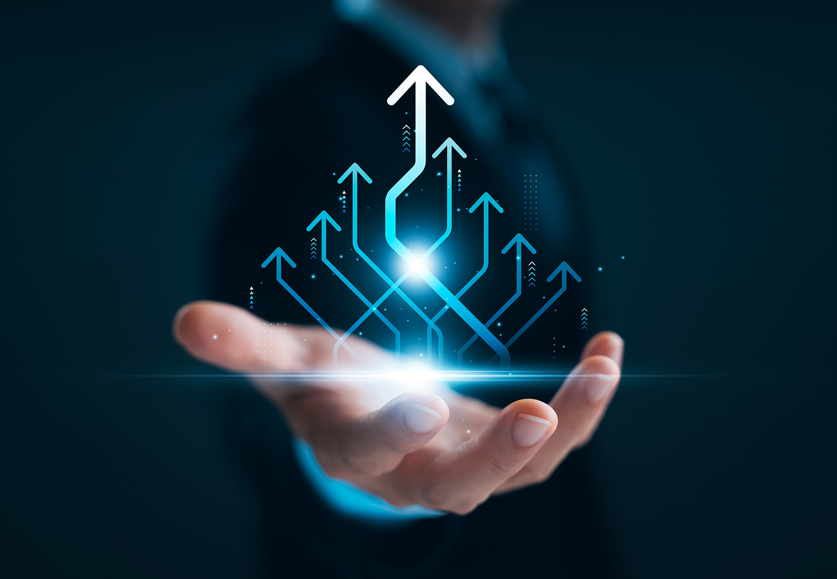 Hand holding upward arrows, symbolizing growth.