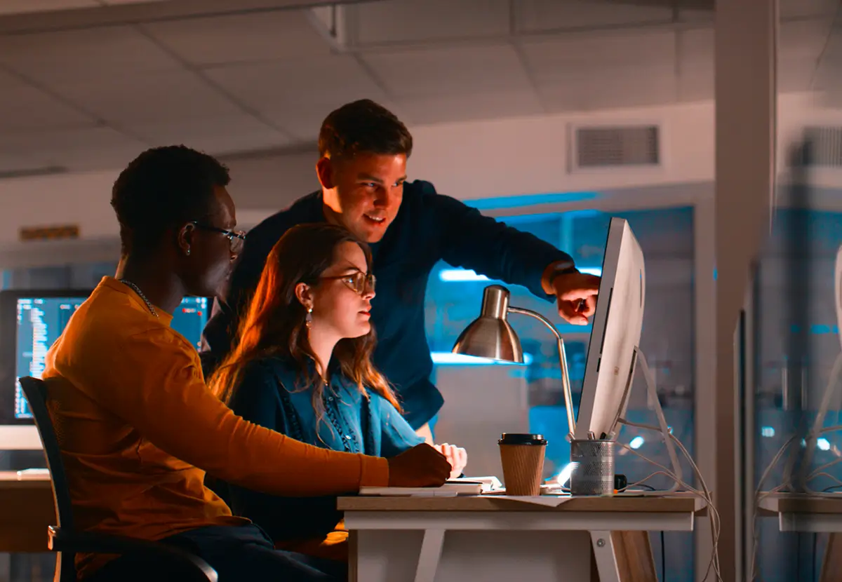 Team working together at computer screen.